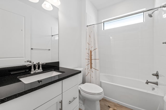 full bathroom with vanity, toilet, wood finished floors, and shower / tub combo with curtain