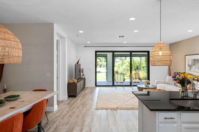 interior space with recessed lighting, baseboards, visible vents, and light wood-style floors