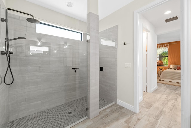 ensuite bathroom with visible vents, ensuite bath, a wealth of natural light, and tiled shower