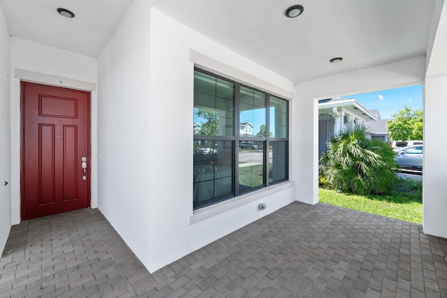 property entrance with stucco siding