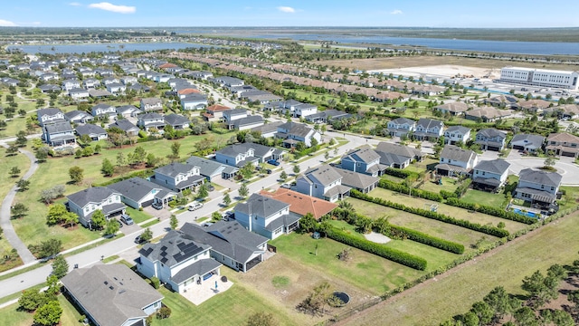 bird's eye view featuring a water view and a residential view