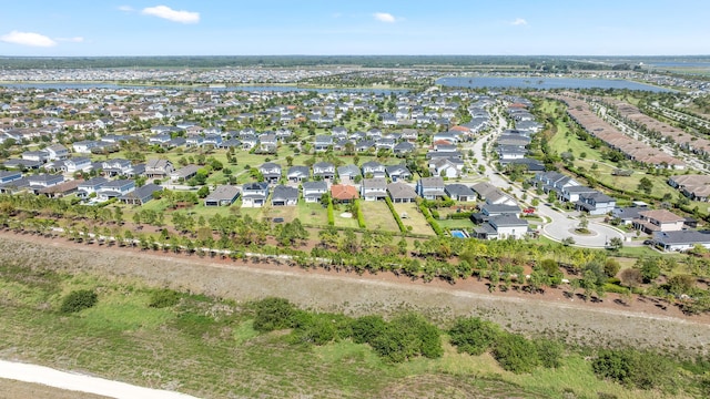 birds eye view of property featuring a residential view and a water view