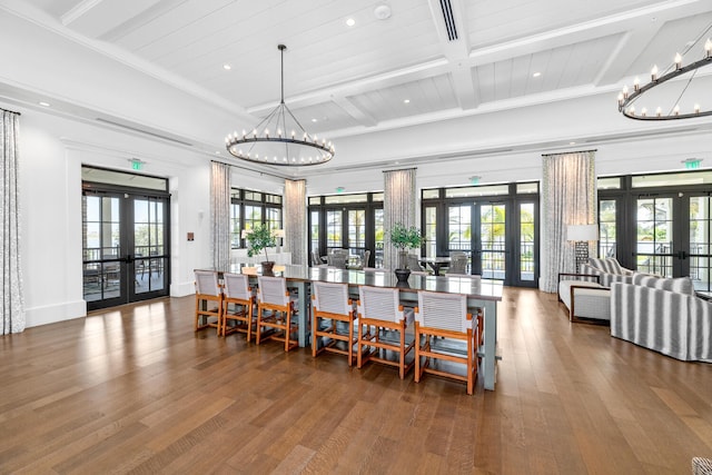 dining area featuring french doors, wood finished floors, and a chandelier