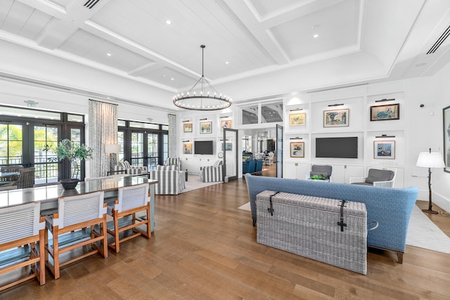 living room with coffered ceiling, french doors, recessed lighting, and wood finished floors