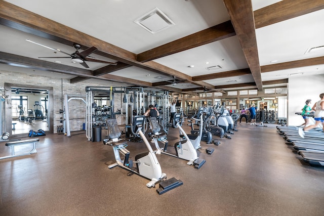 gym with ceiling fan, visible vents, and coffered ceiling