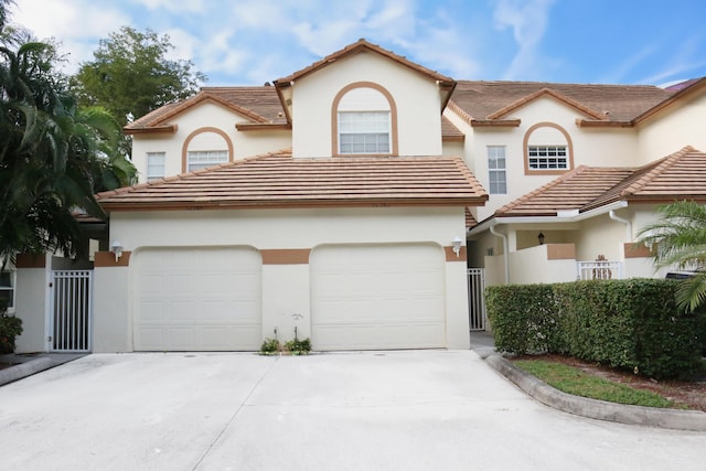 12582 Shoreline Dr, Wellington, FL 33414 - view of front facade with a garage, stucco siding, a gate, a tiled roof, and driveway