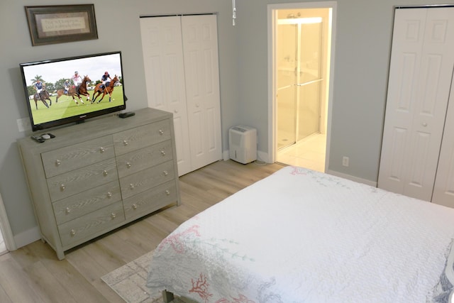 12582 Shoreline Dr, Wellington, FL 33414 - bedroom with connected bathroom, baseboards, and light wood-style flooring