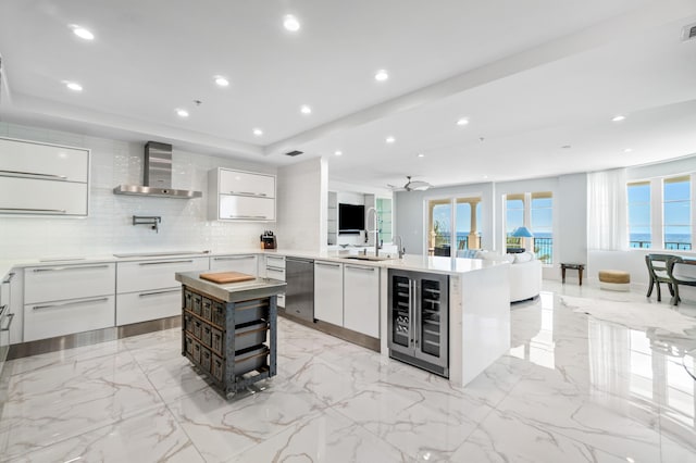 kitchen with modern cabinets, wine cooler, wall chimney exhaust hood, stainless steel dishwasher, and white cabinets