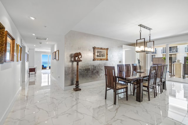 dining space featuring baseboards, recessed lighting, a chandelier, and light marble finish floors