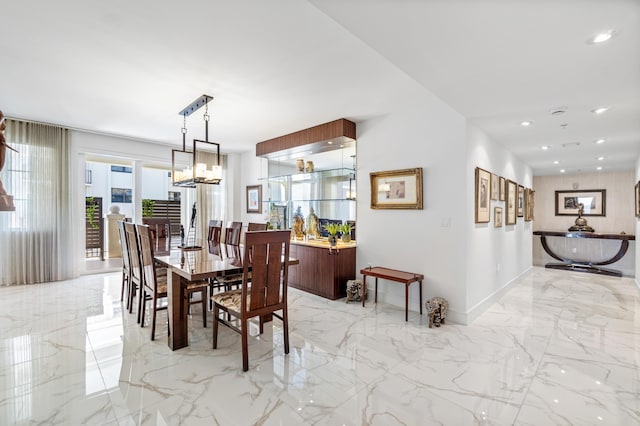 dining room with light marble finish floors, a chandelier, baseboards, and recessed lighting