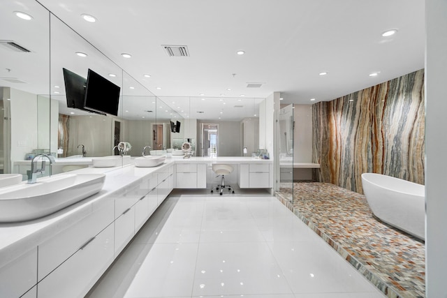 bathroom featuring tile patterned flooring, an enclosed shower, recessed lighting, double vanity, and a soaking tub