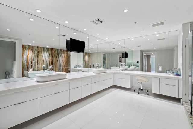 bathroom featuring double vanity, tile patterned flooring, and recessed lighting