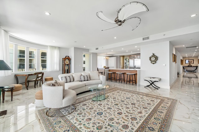 living room featuring light marble finish flooring, recessed lighting, and ceiling fan