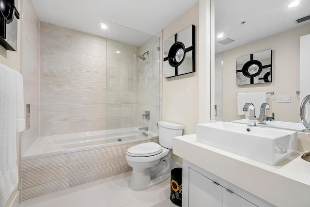 full bath featuring toilet, tile patterned floors, tiled shower / bath, recessed lighting, and vanity