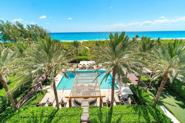 community pool featuring a water view and a patio
