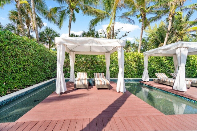 deck featuring an outdoor pool and a gazebo
