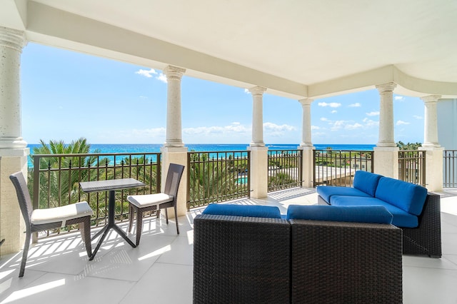 balcony featuring a water view and outdoor lounge area