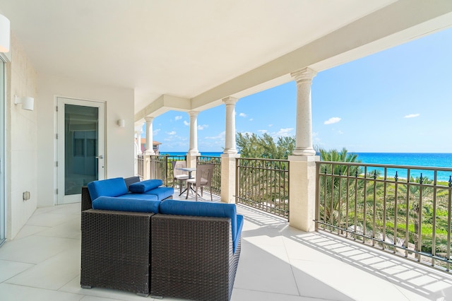view of patio / terrace with a water view and a balcony