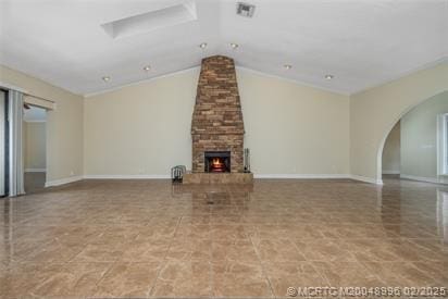 5361 SW Windward Way, Palm City, FL 34990 - unfurnished living room featuring arched walkways, lofted ceiling, a stone fireplace, and baseboards