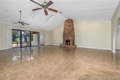 5361 SW Windward Way, Palm City, FL 34990 - unfurnished living room featuring lofted ceiling, a ceiling fan, baseboards, a stone fireplace, and tile patterned flooring