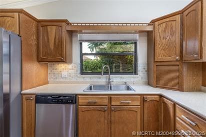 5361 SW Windward Way, Palm City, FL 34990 - kitchen featuring appliances with stainless steel finishes, a sink, light countertops, backsplash, and brown cabinets