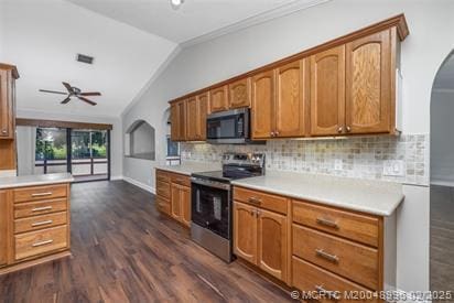 5361 SW Windward Way, Palm City, FL 34990 - kitchen featuring stainless steel appliances, lofted ceiling, a ceiling fan, dark wood-style flooring, and decorative backsplash