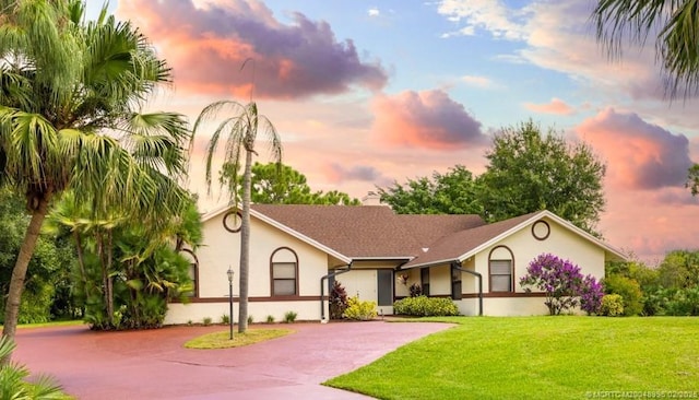 5361 SW Windward Way, Palm City, FL 34990 - view of front of property featuring driveway, stucco siding, and a front lawn