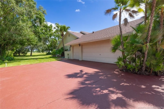 5361 SW Windward Way, Palm City, FL 34990 - view of side of property featuring a lawn, driveway, an attached garage, and roof with shingles