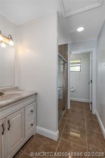 5361 SW Windward Way, Palm City, FL 34990 - full bathroom with tile patterned flooring, a stall shower, vanity, and baseboards
