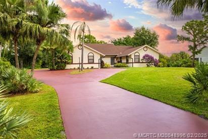 5361 SW Windward Way, Palm City, FL 34990 - view of front of property featuring curved driveway and a front yard