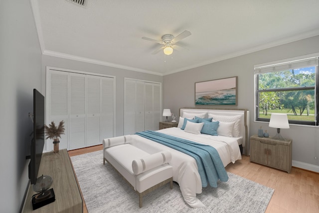 5361 SW Windward Way, Palm City, FL 34990 - bedroom featuring multiple closets, crown molding, light wood finished floors, baseboards, and ceiling fan