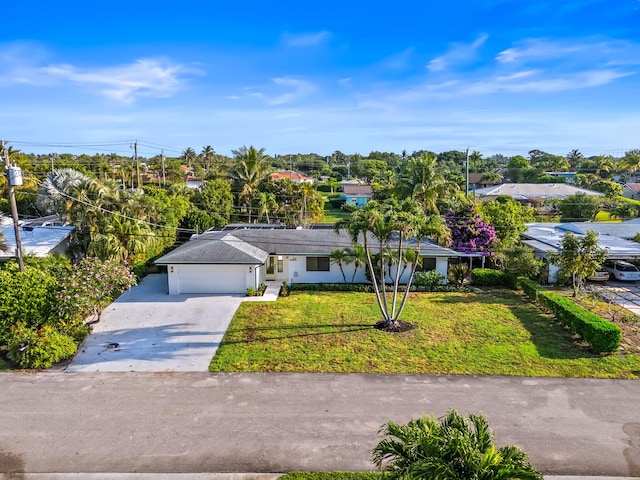1516 Wagner Cir, Lake Clarke Shores, FL 33406 - ranch-style house with stucco siding, concrete driveway, a garage, and a front lawn