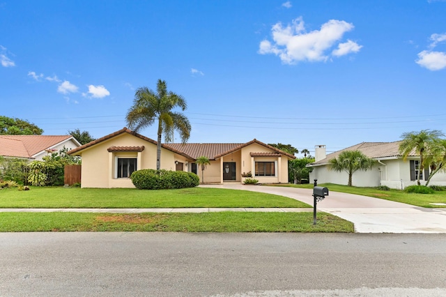 2602 SW 23rd Cranbrook Dr, Boynton Beach, FL 33436 - mediterranean / spanish house featuring stucco siding, a tile roof, and curved driveway