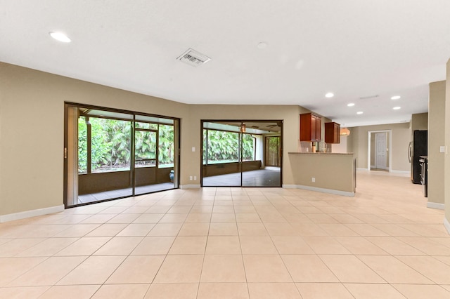 2602 SW 23rd Cranbrook Dr, Boynton Beach, FL 33436 - unfurnished living room with recessed lighting, baseboards, and light tile patterned floors