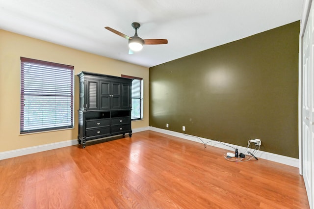 2602 SW 23rd Cranbrook Dr, Boynton Beach, FL 33436 - unfurnished bedroom featuring multiple windows, wood finished floors, and baseboards