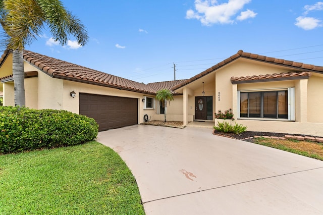 2602 SW 23rd Cranbrook Dr, Boynton Beach, FL 33436 - mediterranean / spanish-style home featuring stucco siding, a tiled roof, driveway, and a garage