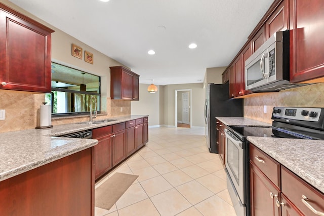 2602 SW 23rd Cranbrook Dr, Boynton Beach, FL 33436 - kitchen with appliances with stainless steel finishes, dark brown cabinets, backsplash, recessed lighting, and light tile patterned flooring