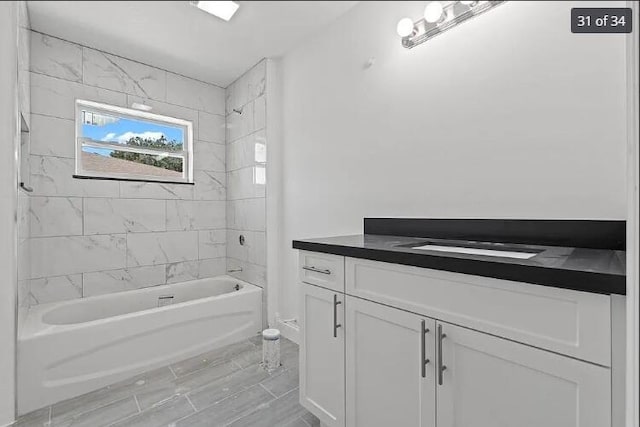 bathroom with tub / shower combination and vanity
