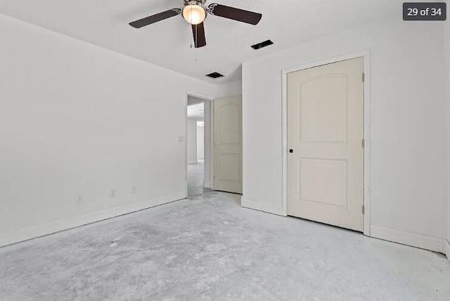 unfurnished bedroom with visible vents, concrete floors, ceiling fan, and baseboards