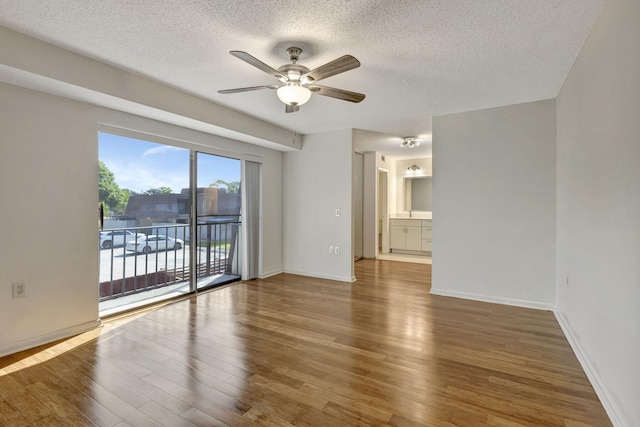 unfurnished room featuring a textured ceiling, ceiling fan, and wood finished floors