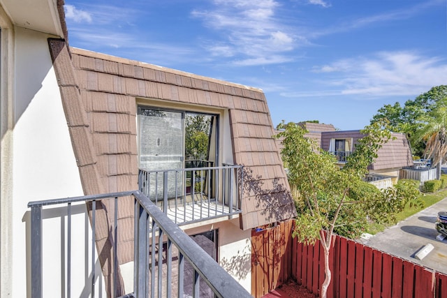 exterior space with stucco siding and a balcony