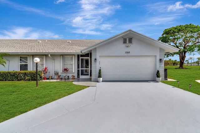 ranch-style home with a garage, a front lawn, stucco siding, a shingled roof, and driveway