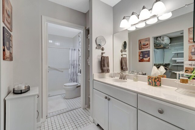 full bath with toilet, curtained shower, tile patterned flooring, and vanity