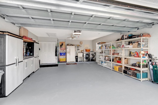 garage with a garage door opener, washing machine and dryer, and white fridge with ice dispenser