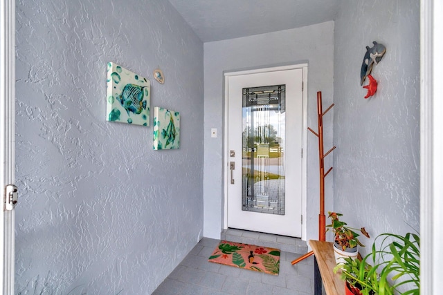 view of exterior entry featuring stucco siding