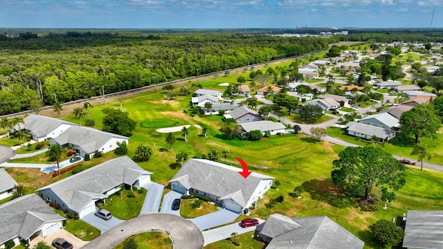 aerial view featuring a view of trees, view of golf course, and a residential view