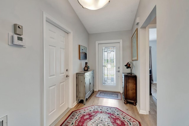 entrance foyer with baseboards and light wood-type flooring
