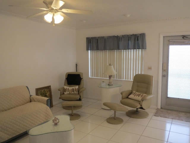 sitting room with tile patterned floors, ceiling fan, and baseboards