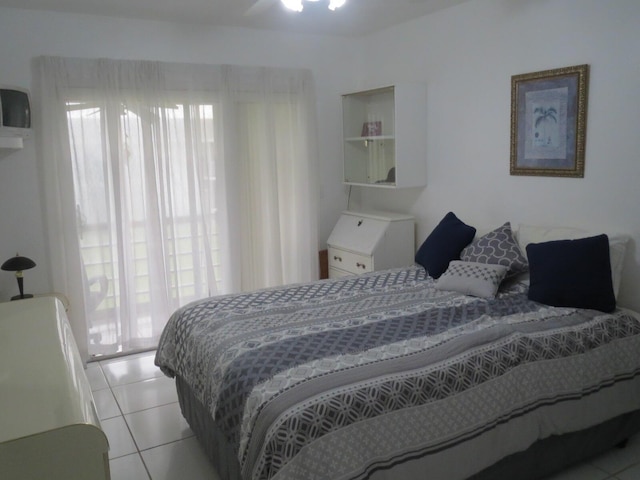 bedroom featuring multiple windows and light tile patterned floors