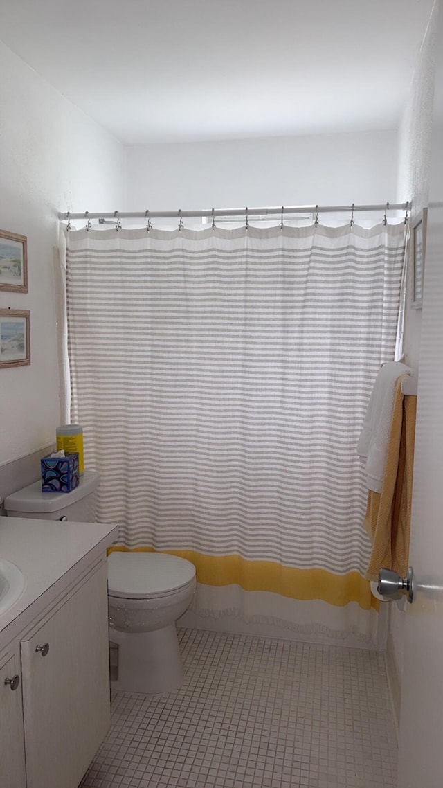 bathroom featuring tile patterned floors, vanity, and toilet